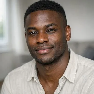 Young Black man, late twenties, short natural hair, calm expression, open-collar shirt